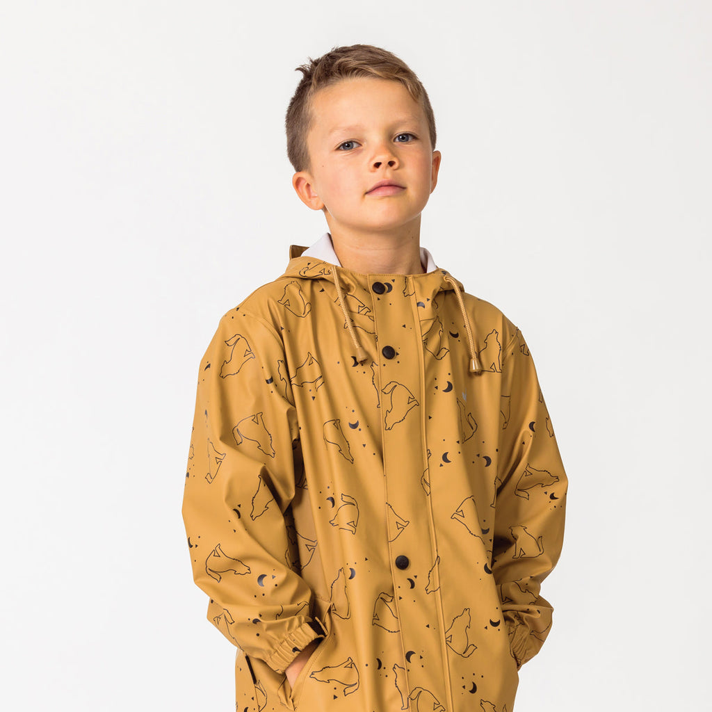 A boy wearing a Play Jacket Wolf Print 